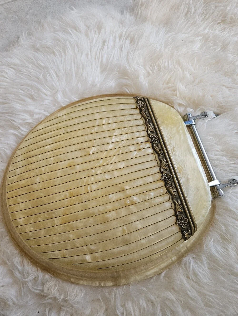 Vintage-Inspired Cream Toilet Seat Round with Decorative Hinge Accent Elegant.